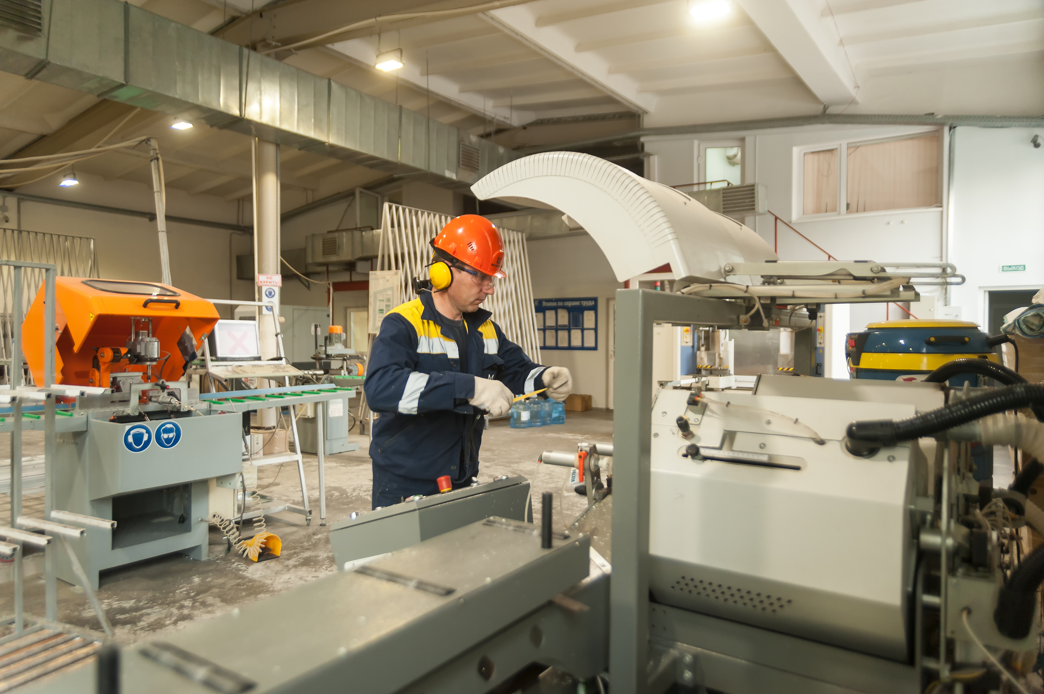 A machinist using large tools to manufacture a product