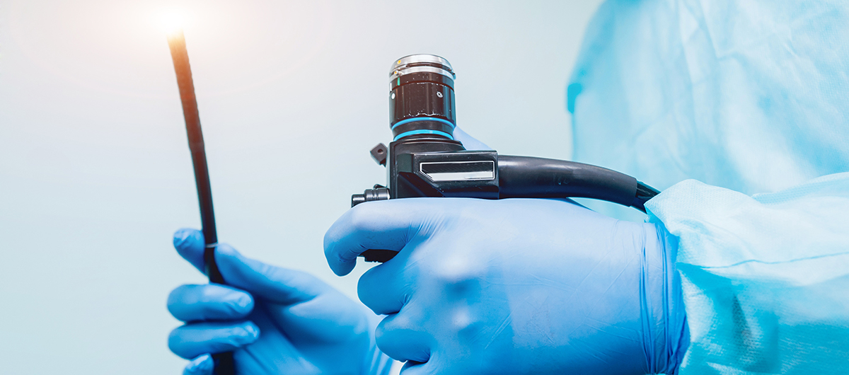 Endoscopy Technician holding an endoscope.