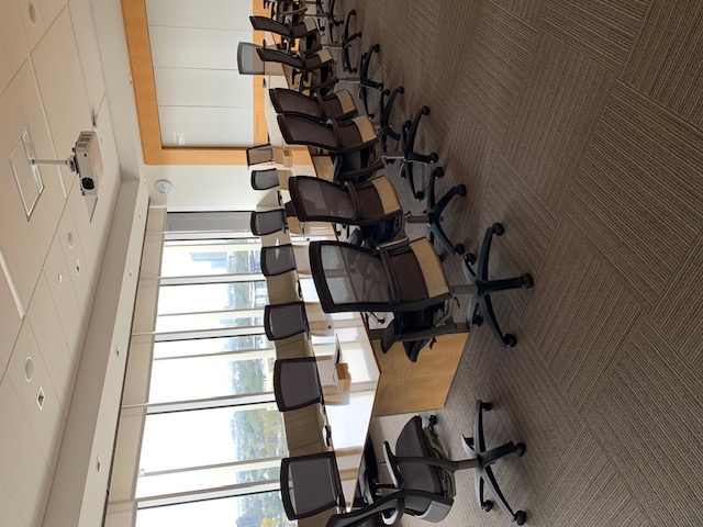 Interior photo of the meeting room space of the Pacific Ocean room showcasing the windowed view of the city.