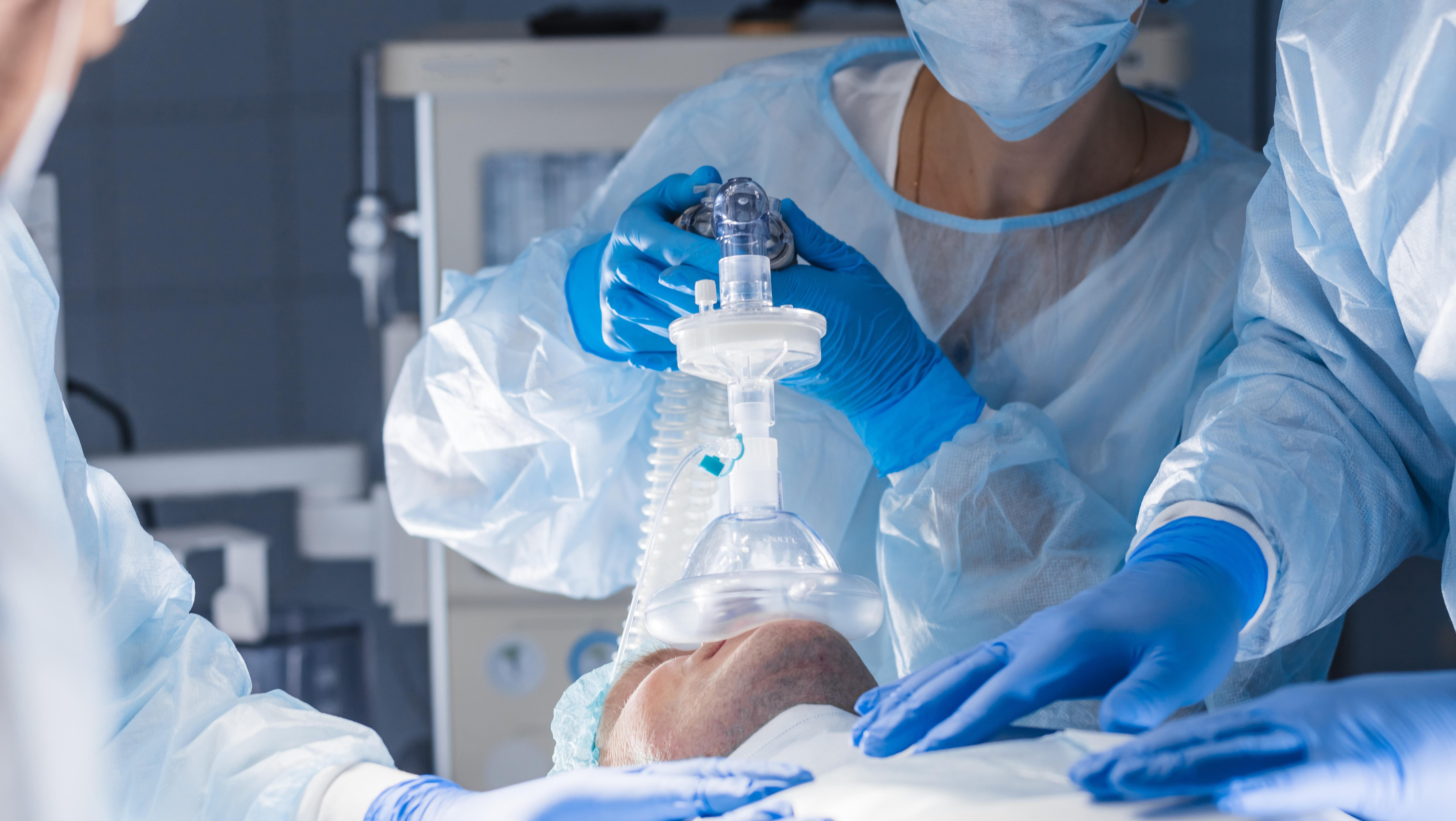 Anesthesist monitoring a patient during a medical procedure