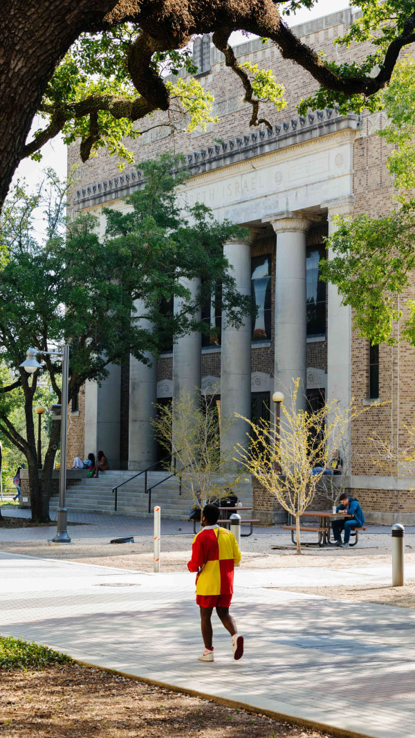 Male student walking across the HCC Central Campus